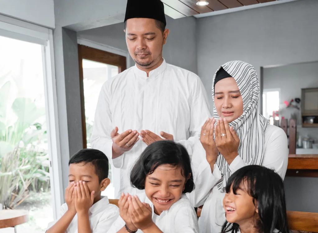 A Muslim family offering gratitude at the dinner table